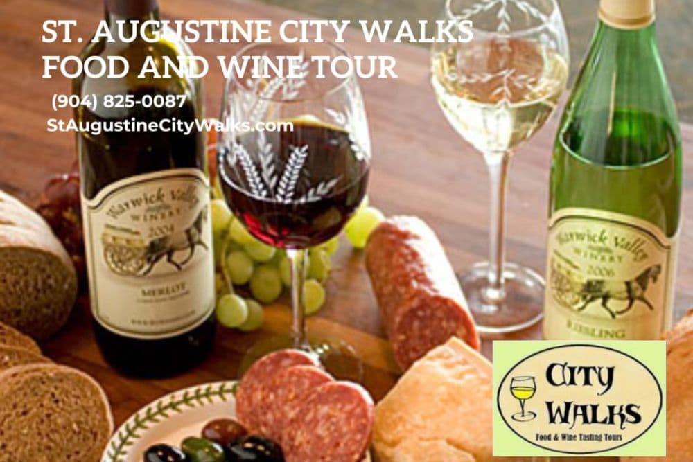 A selection of wines, cheese, salami, and bread, featuring promotional text for St. Augustine City Walks Food and Wine Tour.